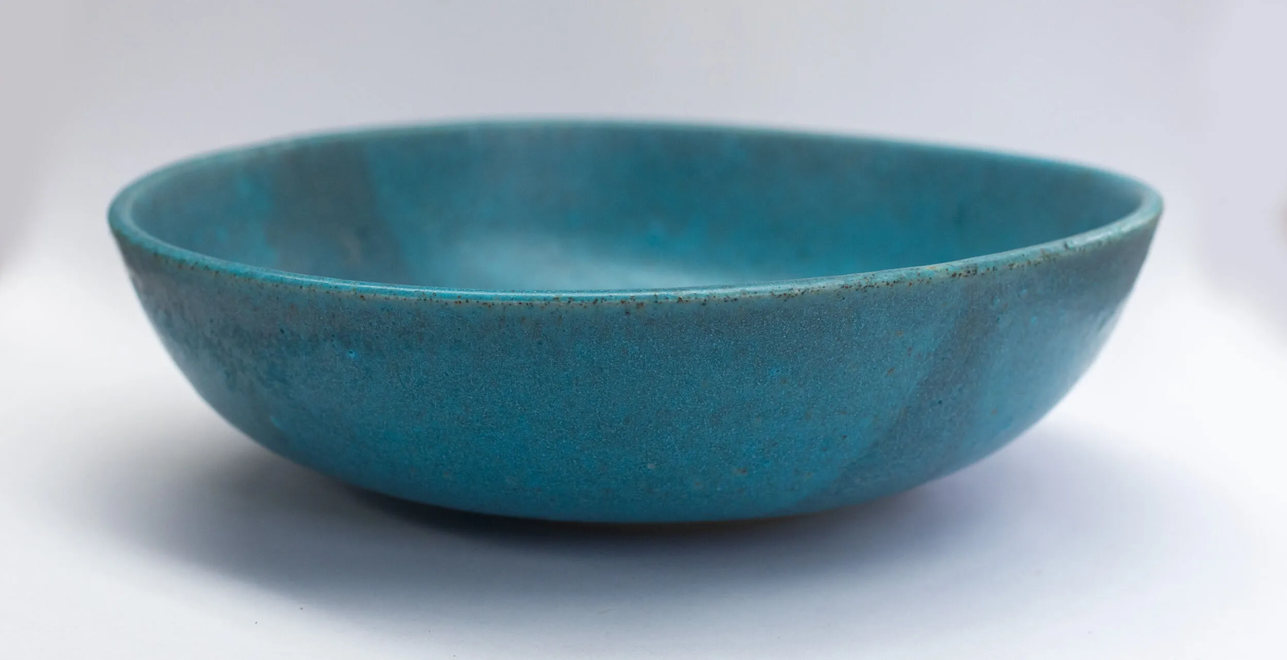 Hand-thrown turquoise ceramic bowl with matte glaze