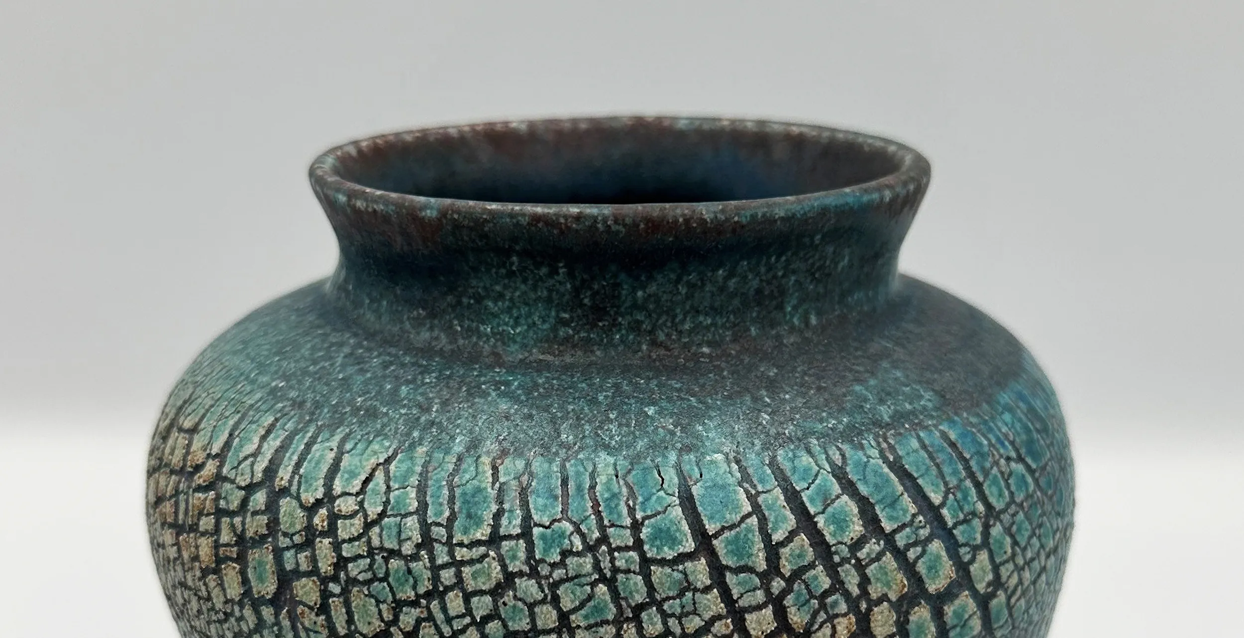 Close-up detail of sodium silicate crackle surface on hand-thrown ceramic vase